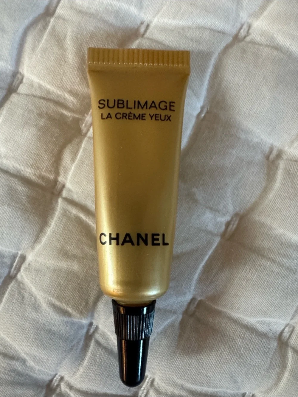 CHANEL Beauté Black and Cream Makeup Pouch and skincare products.